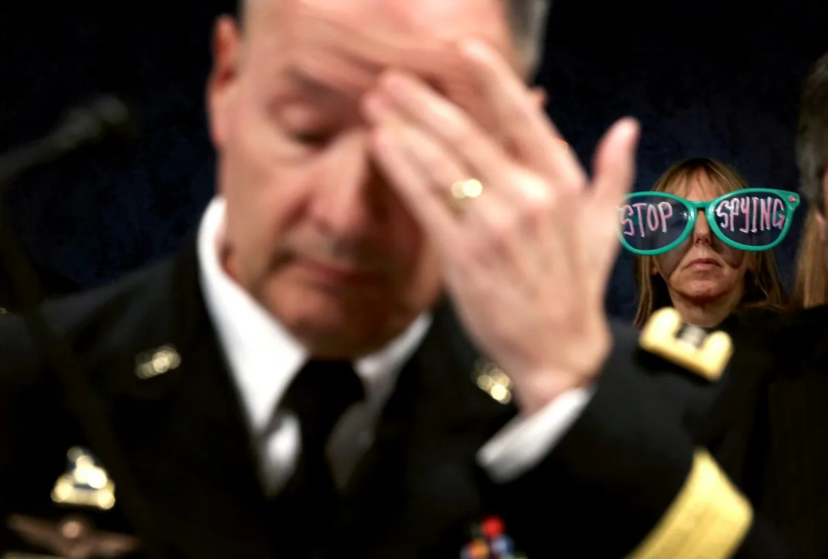 A CodePink member protests behind Director of the National Security Agency Gen. Keith Alexander (L) during a hearing before the House (Select) Intelligence Committee Oct. 29, 2013 in Washington, DC. (Alex Wong/Getty Images)