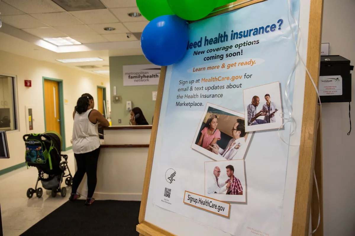 A sign encouraging uninsured people to sign up for the Affordable Care Act, better known as ObamaCare, is displayed for patients as they enter a branch of the Metopolitan Family Health network, in Jersey City, N.J., on Oct. 3, 2013. (Andrew Burton/Getty Images)
