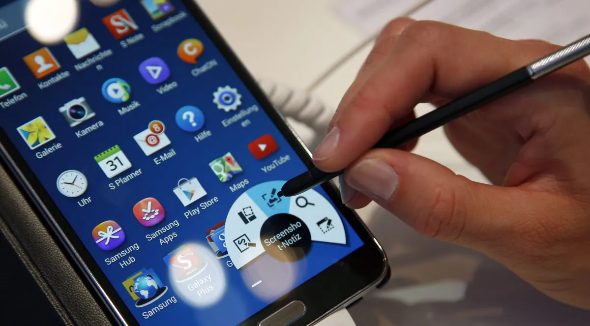 A women works on a Samsung Galaxy Note 3 Smartphone at the IFA, in Berlin, Germany on Friday, Sept. 6, 2013. (AP Photo/Michael Sohn)