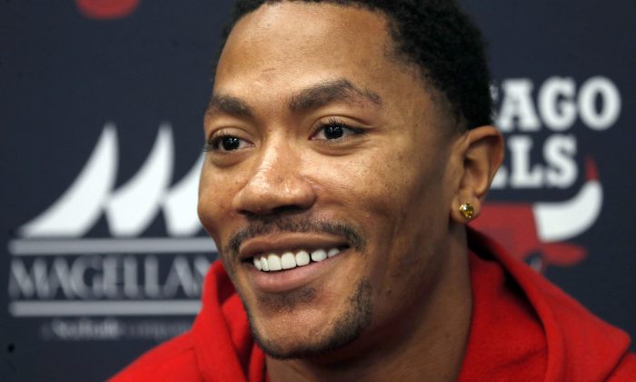 Chicago Bulls guard Derrick Rose smiles during an NBA basketball news conference about his injured knee Thursday, Dec. 5, 2013, at  the United Center in Chicago. (AP Photo/Charles Rex Arbogast)