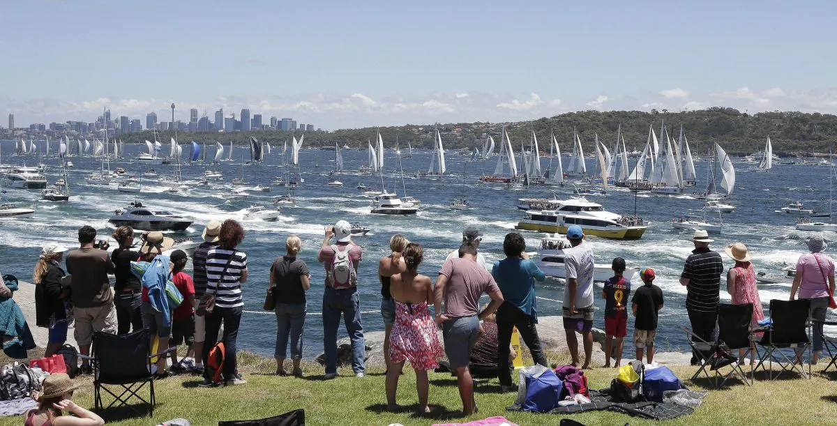 Spectators watch as the fleet sail out of the heads at the start of the Sydney Hobart yacht race in Sydney Thursday, Dec. 26, 2013. (AP Photo/Glenn Nicholls)