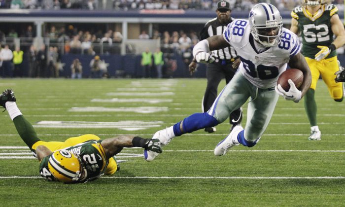 Green Bay Packers strong safety Morgan Burnett (42) stops Dallas Cowboys wide receiver Dez Bryant (88) short of the goal line during the first half of an NFL football game, Sunday, Dec. 15, 2013, in Arlington, Texas. (AP Photo/Tim Sharp)