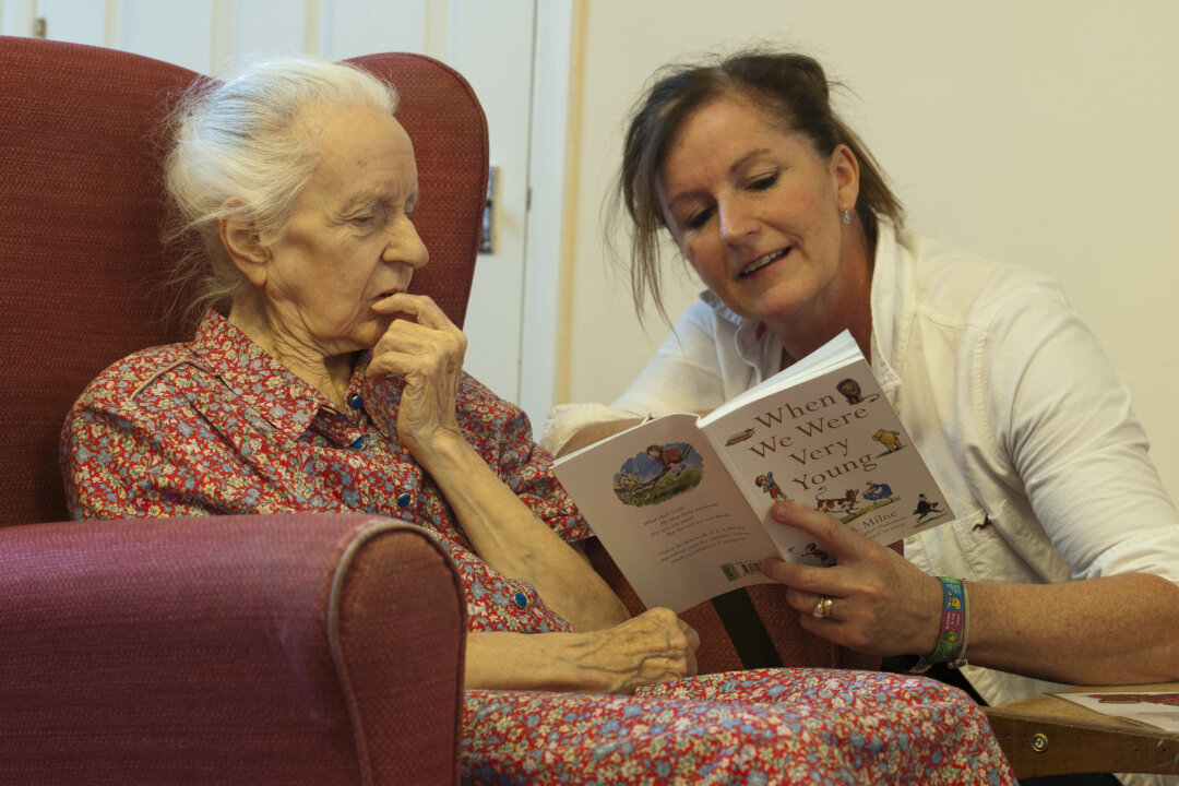 A volunteer reads poems to a dementia sufferer at a care home in Stratford, UK, in an undated file photo. (Will Oliver/AFP/Getty Images)
