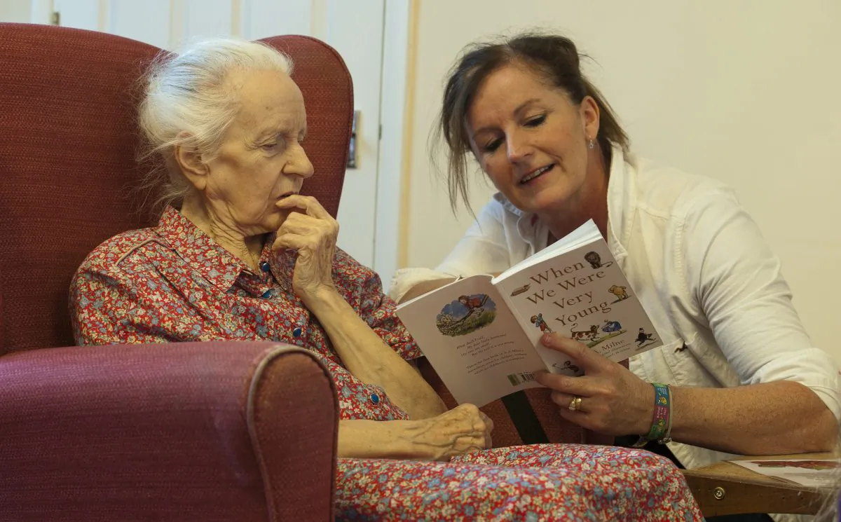 A volunteer reads poems to a dementia sufferer at a care home in Stratford, UK, in an undated file photo. (Will Oliver/AFP/Getty Images)