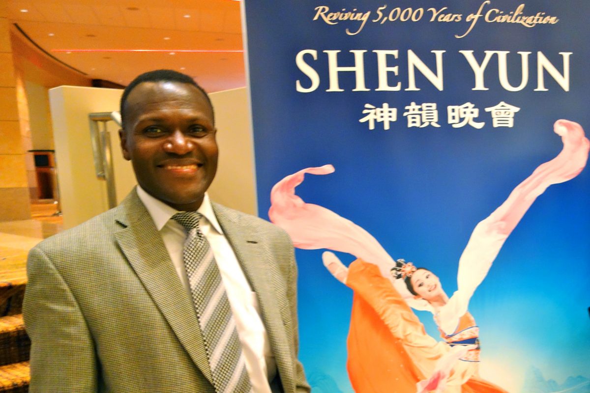 Mr. Otswila Nawade never misses Shen Yun Performing Arts when it visits Atlanta. He is in the lobby of the Cobb Energy Centre in Atlanta on Dec. 29. (Mary Silver/Epoch Times) 