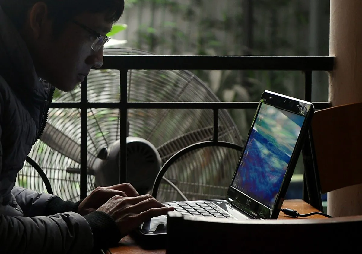 A man uses a laptop at a coffee shop in Hanoi, Vietnam, on Nov. 28, 2013. (Hoang Dinh Nam/AFP/Getty Images)