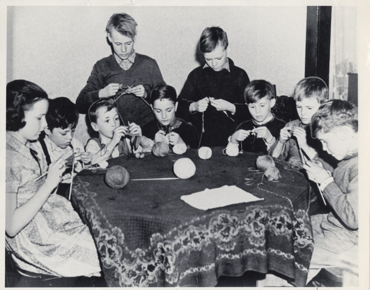 These boys and girls helped knit millions of socks and other garments for Canadian service personnel. Voluntary organizations like the Canadian Red Cross and the Navy League of Canada distributed them and other comforts overseas. (Canadian War Museum)