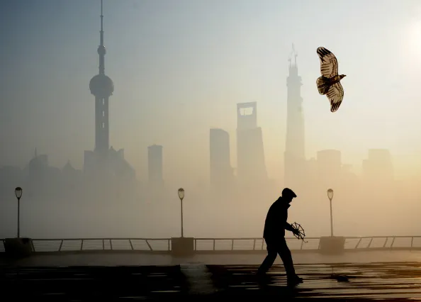 A man flies kite at The Bund on December 5, 2013 in Shanghai, China. Heavy smog continued to hit northern and eastern parts of China, disturbing the traffic, worsening air pollution and forcing the closure of schools. (ChinaFotoPress/ChinaFotoPress via Getty Images)
