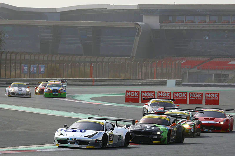 The #30 Ram Racing Ferrari leads a string of cars around the Dubai racecourse early in the race. The Ram Ferrari should be back on track by the fourteen-hour mark, after a collision just before 13 hours sent it to the garage. (http://live.24hseries.com)
