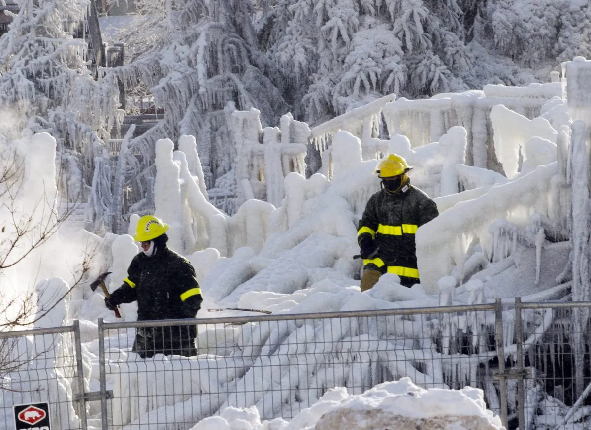 Rescue personnel search through the icy rubble of fire that destroyed a seniors' residence Friday, Jan. 24, 2014, in L'Isle-Verte, Quebec. (The Canadian Press/Ryan Remiorz)