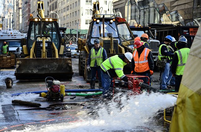 Crews gather around the sinkhole caused by a water main break at 13th Street and 5th Avenue, New York City, Jan. 15, 2014.  (Courtesy of Albin Lohr-Jones)