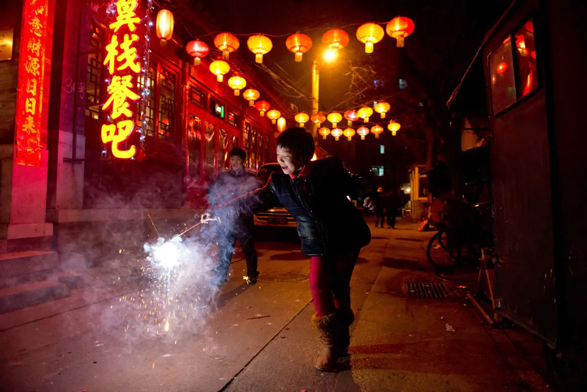A girl holds a firecracker in an alleyway in Beijing during the Lantern Festival, which marks the end of celebrations for the Chinese New Year period. (Ed Jones/AFP/Getty Images)