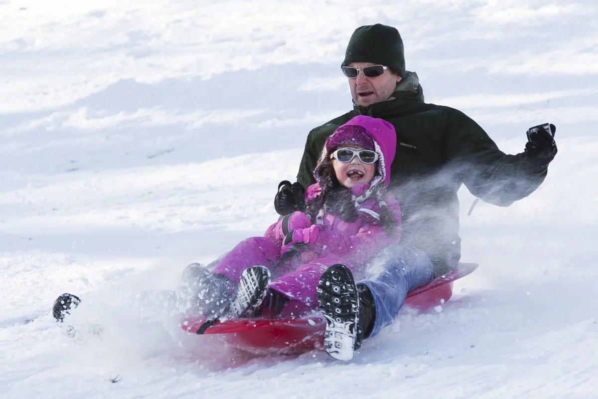 People enjoy sledding and tobogganing south of the Metropolitan Museum in Central Park in New York on Jan 3, 2014. (Samira Bouaou/Epoch Times)