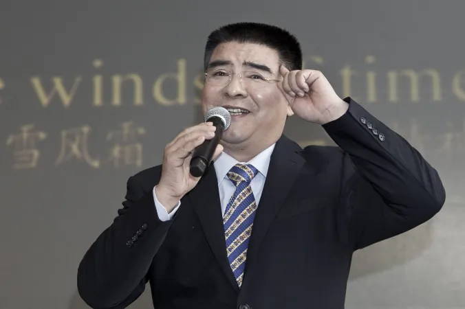 Chen Guangbiao sings karaoke at a press conference he called for the morning of Tuesday, Jan. 7, in a hotel in New York City. His eccentric presentation cloaked a serious purpose, reviving a propaganda hoax, argues R.J. Mitchell. (Samira Bouaou/Epoch Times)