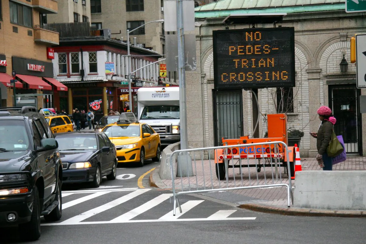A woman waits to cross southbound Broadway at 96th Street, Manhattan, New York, Jan. 20, 2014. This intersection has been especially deadly for pedestrians recently. (Kristina Skorbach/Epoch Times)