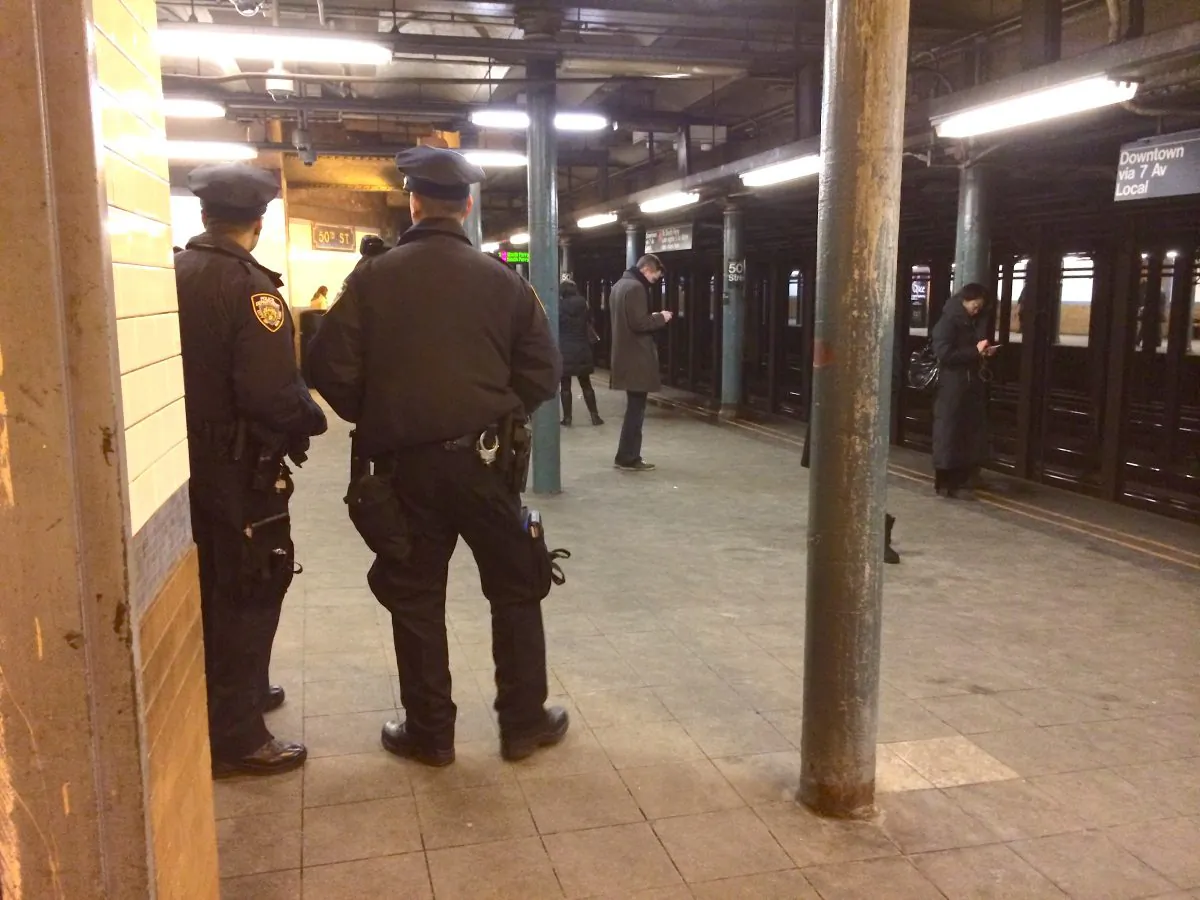 NYPD officers at the 50th St. subway station in Manhattan, New York, Jan. 29, 2014. An extra police police presence is monitoring subway stations in the week before Super Bowl XLVIII. (Matt Gnaizda)
