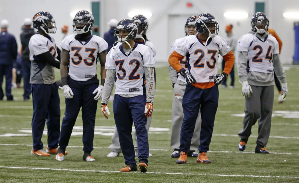 Denver Broncos defensive players Duke Ihenacho (33), Tony Carter (32), Quentin Jammer (23) and Champ Bailey (24) wait to begin a drill during practice Friday, Jan. 31, 2014, in Florham Park, N.J. The Broncos are scheduled to play the Seattle Seahawks in the NFL Super Bowl XLVIII football game Sunday, Feb. 2, in East Rutherford, N.J. (AP Photo/Mark Humphrey)