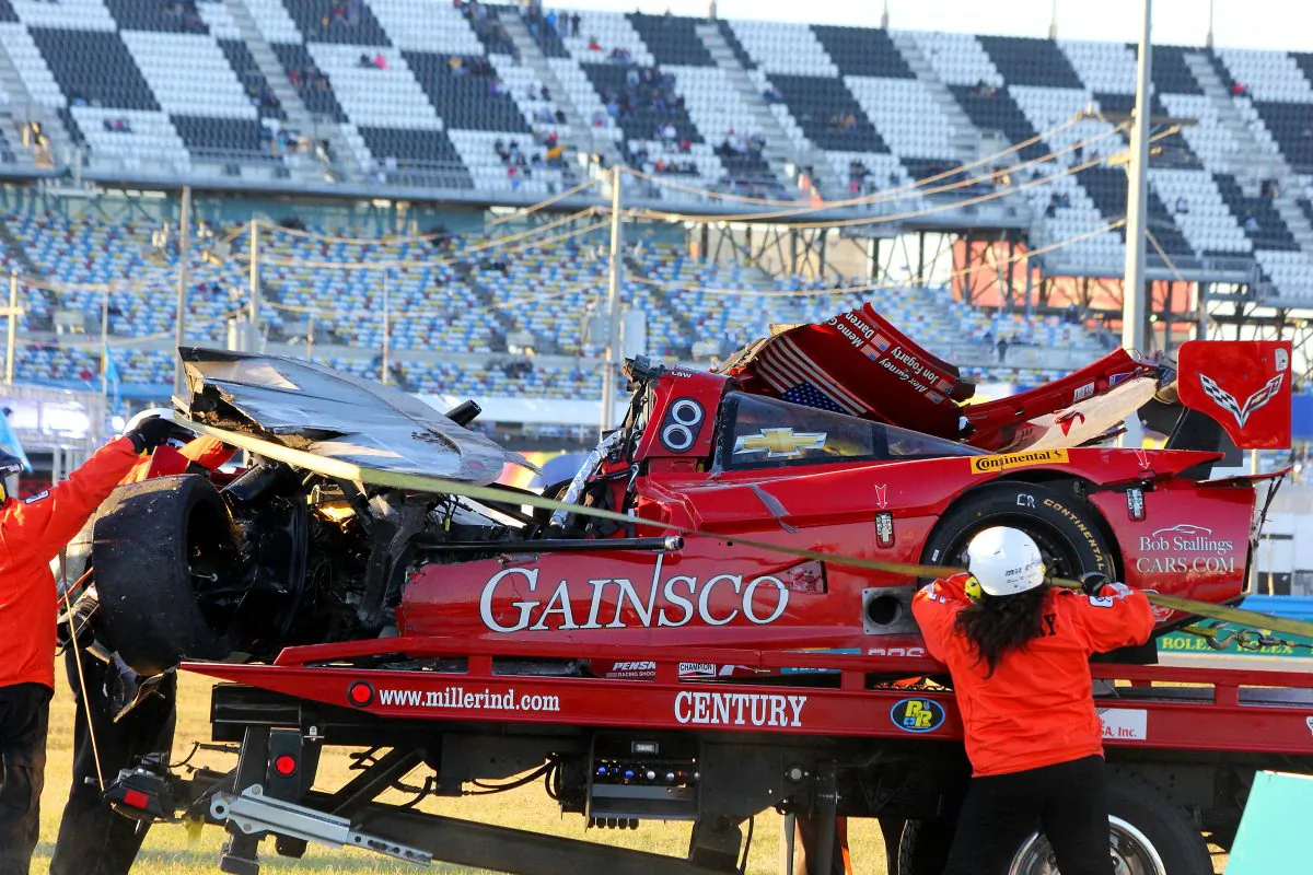 Track workers winch the ruined #99 Gainsco Riley-Corvette onto a flatbed. (Chris Jasurek/Epoch Times)