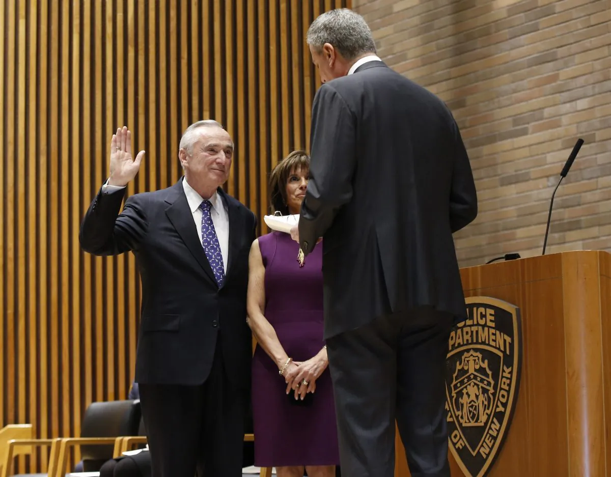 New York City mayor Bill de Blasio (R) reads the oath during the swearing-in of incoming Police Commissioner Bill Bratton, with his wife Rikki Klieman, at police headquarters, New York, Jan. 2, 2013. (Kathy Willens/AP)

