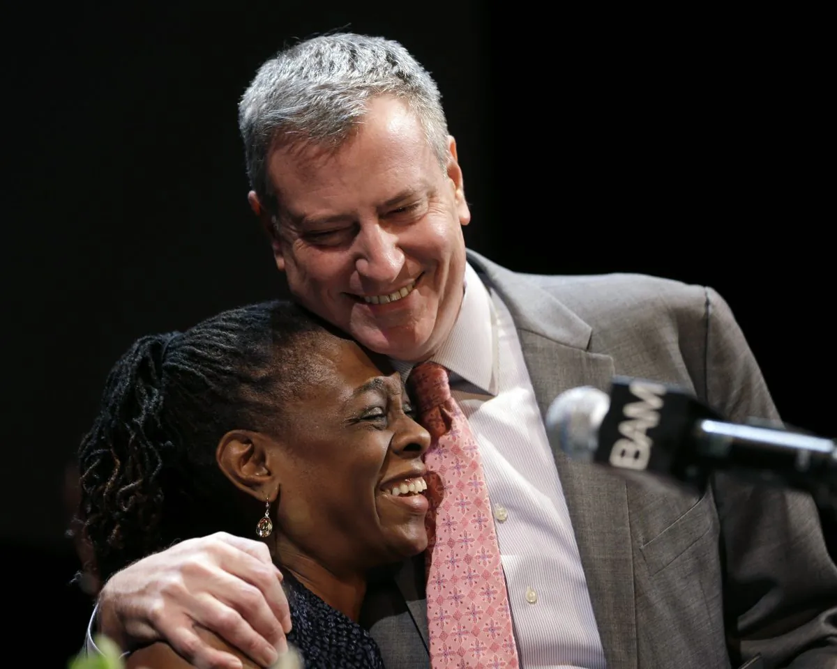New York City Mayor Bill de Blasio hugs his wife Chirlane McCray at a tribute to Martin Luther King, Jr. in the Brooklyn borough of New York, Monday, Jan. 20, 2014. De Blasio appointed McCray as head of the Mayor's Fund to Advance New York City on Thursday. (AP Photo/Seth Wenig)