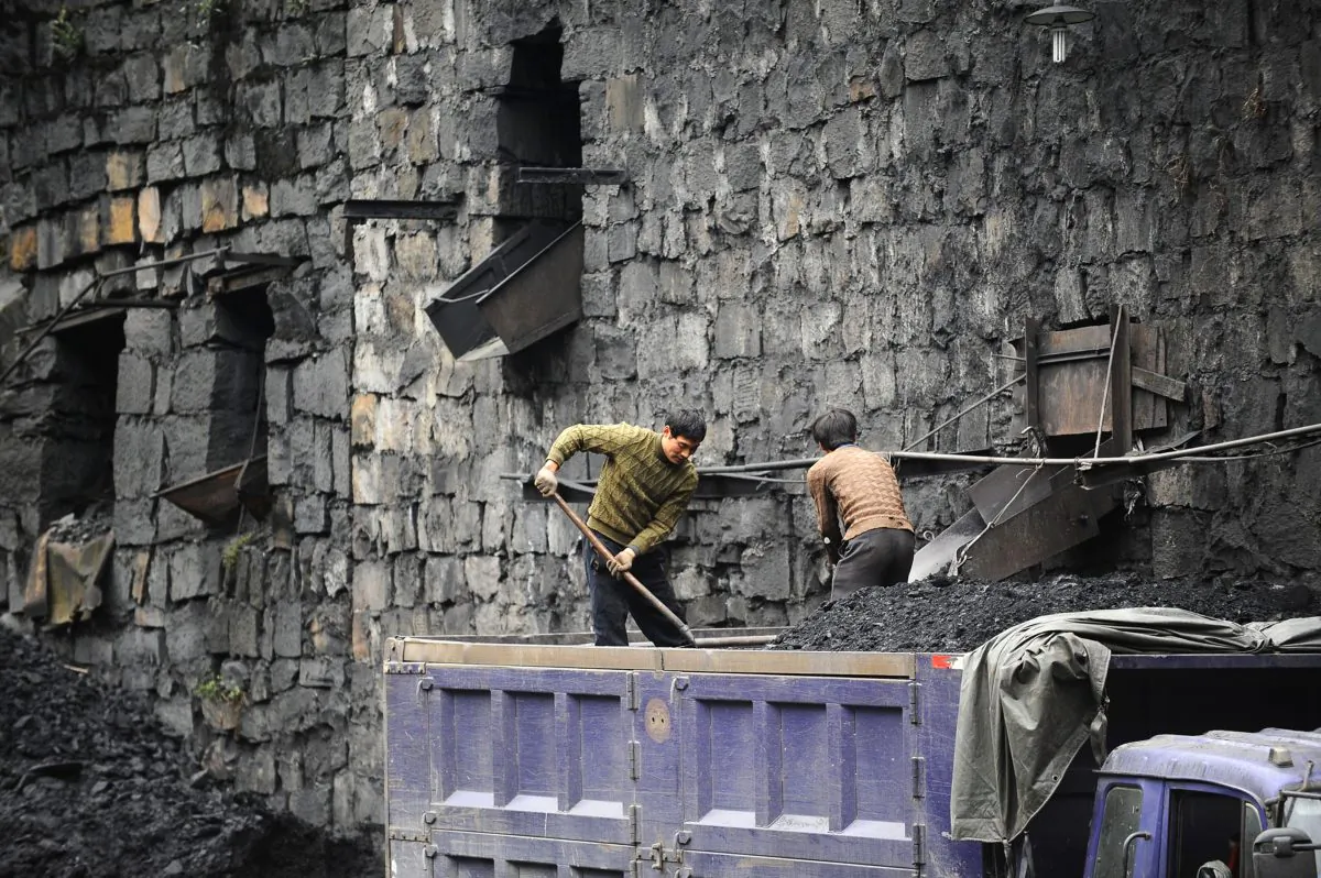 Chinese coal miners load coal into trucks in a mine in southwestern China's Sichuan Province, on Dec. 10, 2009. (AFP/Getty Images)