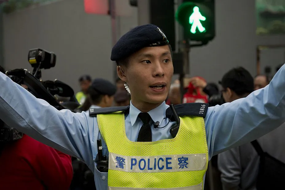 A Hong Kong policeman urges people to disperse after a minor scuffle between protesters during a pro-democracy demonstration in Hong Kong on Jan. 1, 2014. Thousands marched in Hong Kong to demand a greater say in how their future leaders will be chosen, expressing fears that China will limit long-awaited political reforms. (Alex Ogle/AFP/Getty Images)