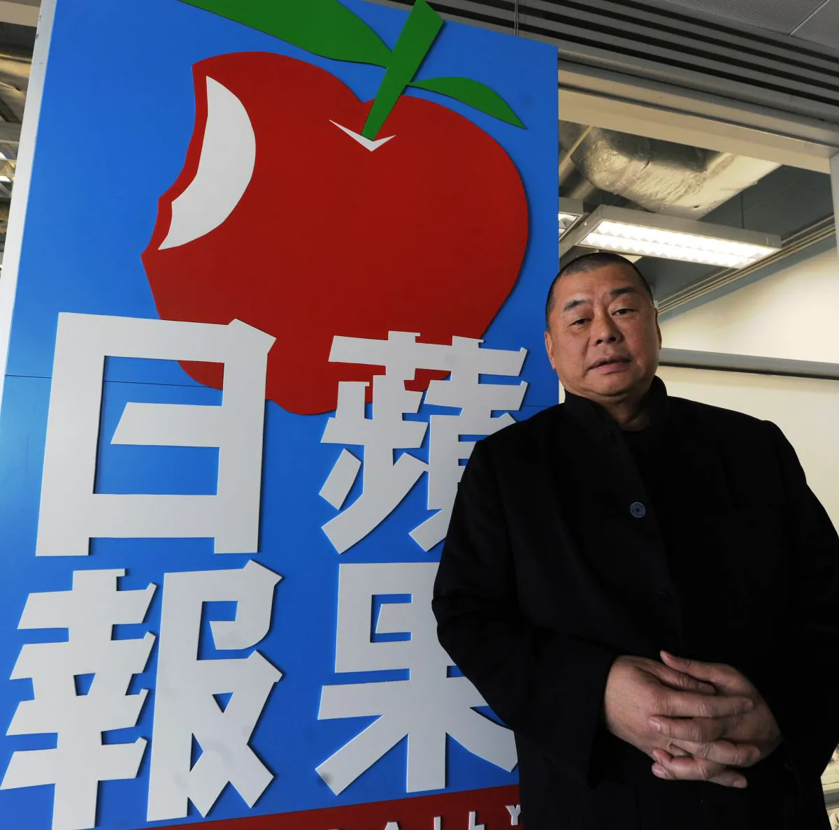 Jimmy Lai stands outside the headquarters of his Next Media company, on Feb. 7, 2011. (Mike Clarke/AFP/Getty Images)