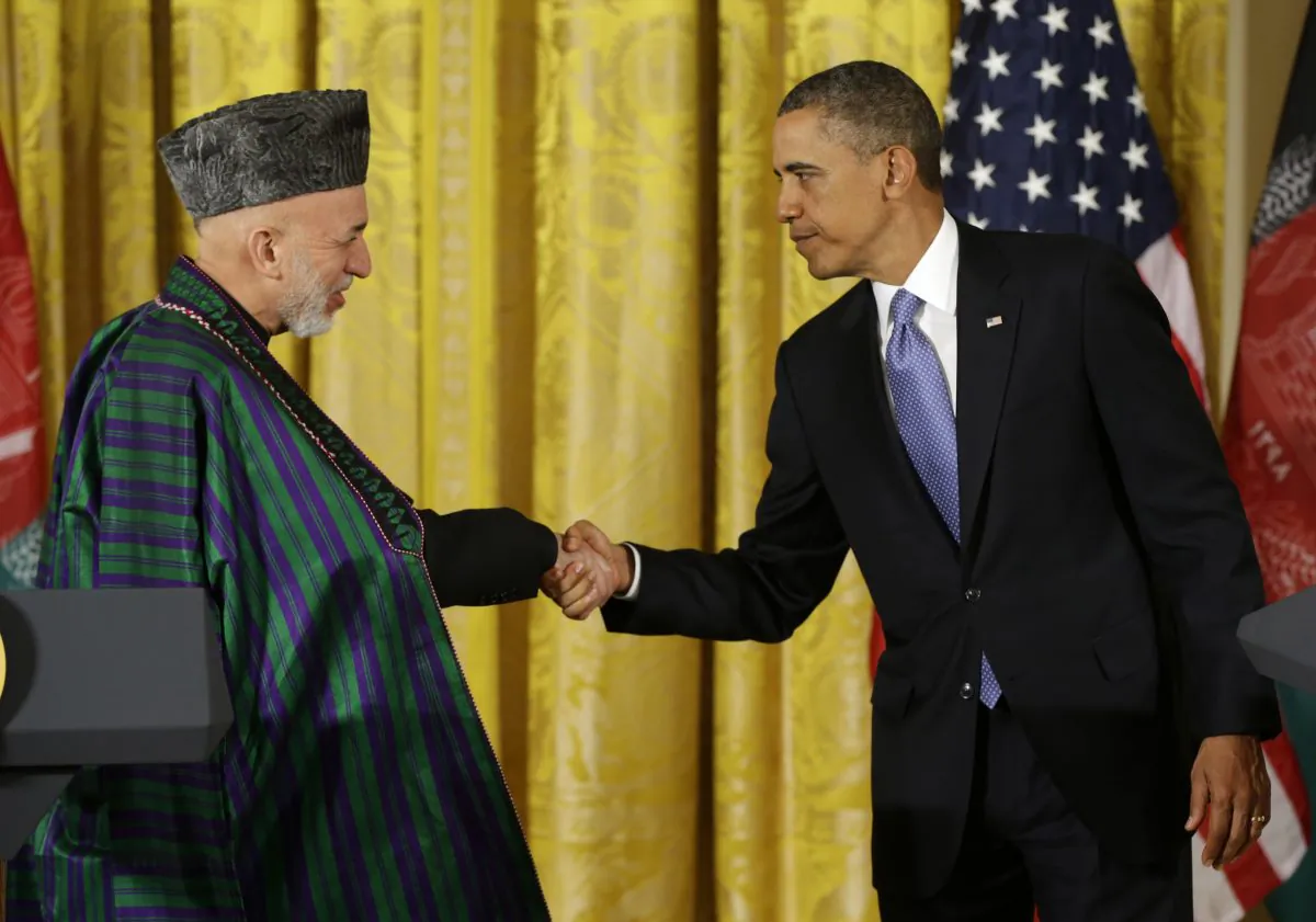 In this Jan. 11, 2013, file photo, President Barack Obama shakes hands with Afghan President Hamid Karzai at the end of their news conference in the East Room of the White House in Washington. Five years after pledging to remake the U.S. relationship with the broader Middle East and improve America's image in the Muslim world, the Obama administration's regional strategy appears to have come unhinged. (AP Photo/Pablo Martinez Monsivais, File)