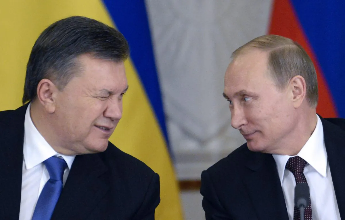 Ukrainian President Viktor Yanukovych winks at Russia's President Vladimir Putin (R) during a signing ceremony at the Kremlin in Moscow, Dec. 17, 2013. Putin said that the state energy companies of Russia and Ukraine had signed an amended agreement slashing the price Moscow charges its cash-strapped neighbor for natural gas. (Alexander Nemenov/AFP/Getty Images)