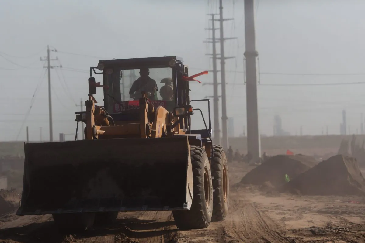 A wheel loader drives on a road near a "toxic lake" surrounded by rare earth refineries near the inner Mongolian city of Baotou on Aug. 19, 2012. (Ed Jones/AFP/Getty Images)