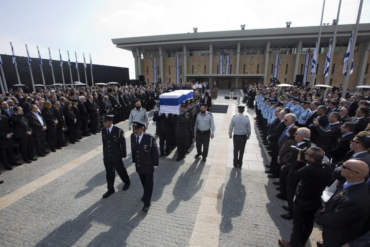 The coffin of late Israeli Prime Minister Ariel Sharon is carried after a memorial ceremony outside the Knesset, in Jerusalem, Jan. 13, 2014. (AP Photo/Sebastian Scheiner)