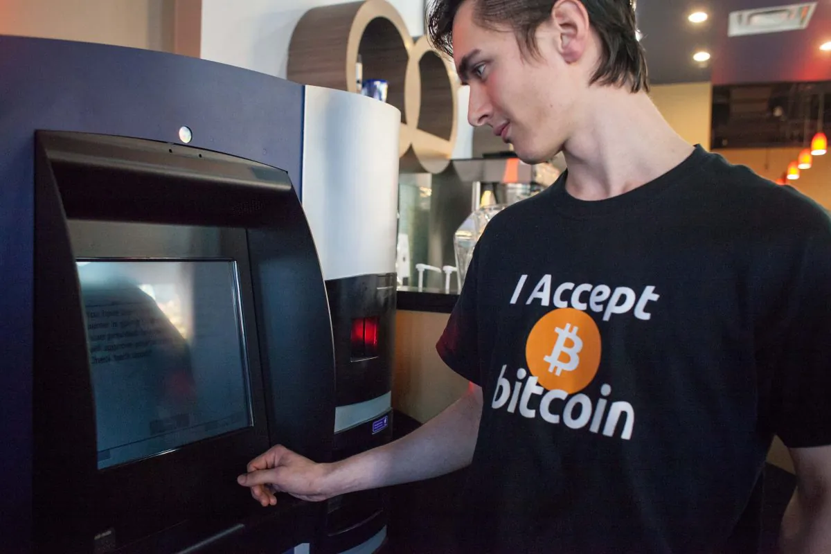 Gabriel Scheare uses the world's first bitcoin ATM on October 29, 2013, at Waves Coffee House in Vancouver. A Calgary-based company has launched Canada's first Bitcoin access card to make it easy for people to buy the digital currency. (David Ryder/Getty Images)