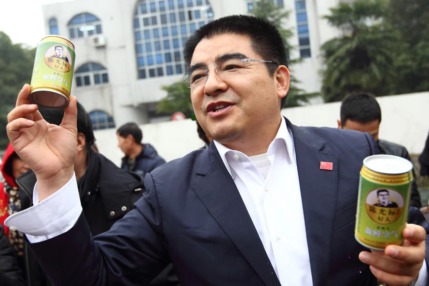 Chen Guangbiao, Chairman of Jiangsu Huangpu Recycling Resources Co., Ltd, presents his company's canned fresh air on Beijing Financial Street, Jan. 30, 2013, in Beijing. (screenshot/China News/Epoch Times)