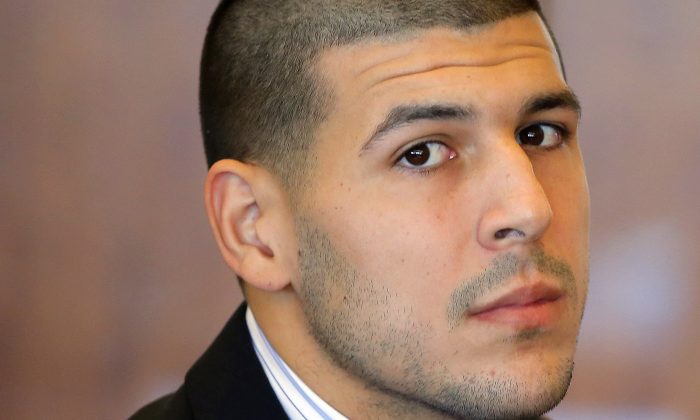 In this Oct. 9, 2013, file photo, former New England Patriots NFL football player Aaron Hernandez attends a pretrial court hearing in Fall River, Mass. Hernandez has pleaded not guilty to killing Odin Lloyd, 27, a semi-professional football player from Boston who was dating the sister of Hernandez's girlfriend. Police wrote in a June 28, 2013 search warrant application that there was probable cause to believe that Hernandez was driving a vehicle used in a separate double slaying of Daniel Jorge Correia de Abreu and Safiro Teixeira Furtado, in Boston, and "may have been the shooter." (AP Photo/Brian Snyder, Pool, File)