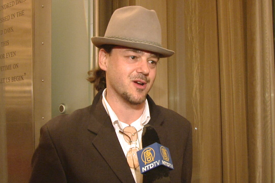 Mr. David Schultens enjoyed the animated backdrops in Shen Yun Performing Arts at Washington's Kennedy Center Opera House on Jan. 25. (Courtesy of NTD Television)