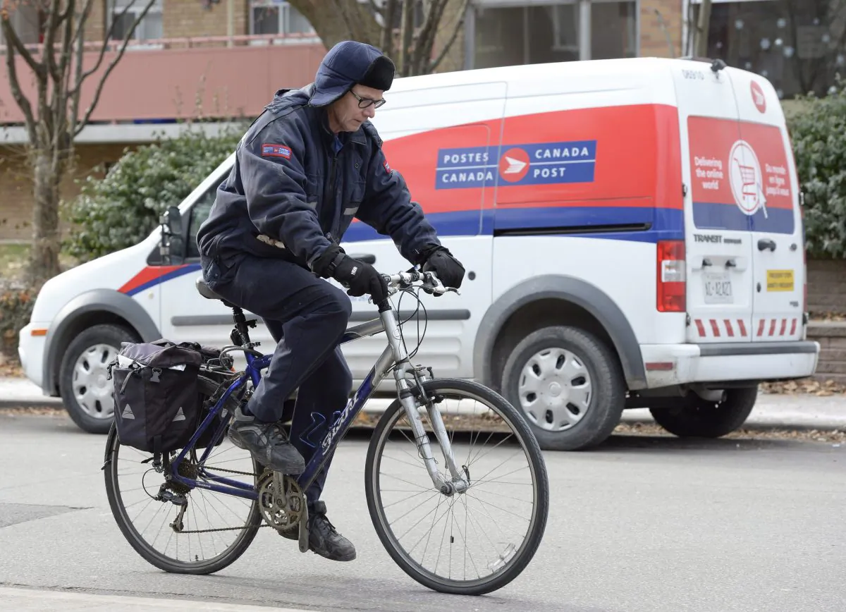 A postal worker rides past a Canada Post van in Toronto on Wednesday, Dec. 11, 2013. The Crown corporation's plans to phase out home delivery have faced sharp criticism but Gwyn Morgan argues the move reflects economic realities, as does the need to convert defined benefit pension plans. (The Canadian Press/Frank Gunn)