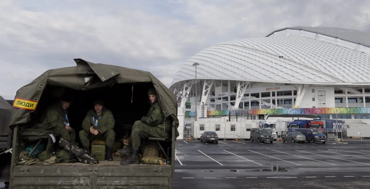 Security personnel sit in the back of a truck outside the Fisht Olympic Stadium in Sochi, Russia, Jan. 27, 2014. (AP Photo/David J. Phillip)