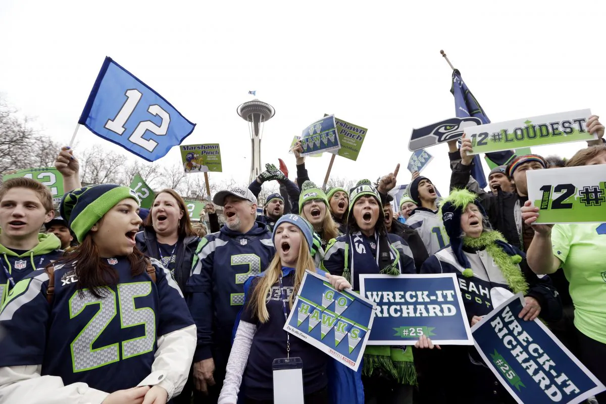 Seattle Seahawks fans cheer at a rally for the team near the Space Needle Wednesday, Jan. 29, 2014, in Seattle. (AP Photo/Elaine Thompson)