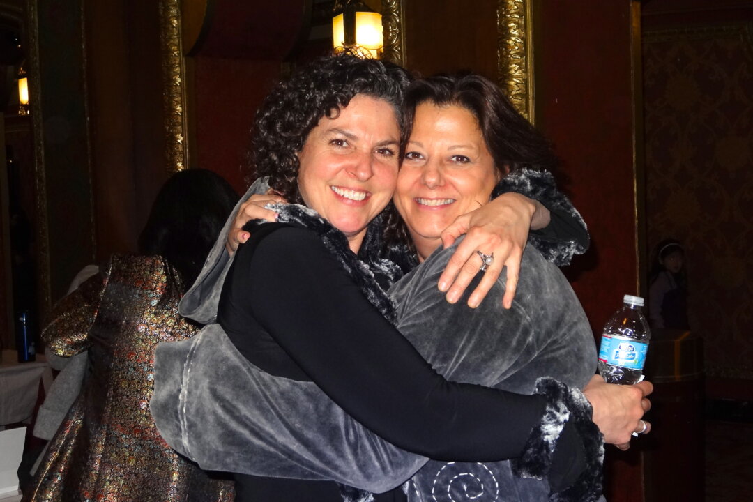 Gina Mark and her friend, Dina Dryden, enjoy Shen Yun Performing Arts at the Providence Performing Arts Center on Sunday. (Huiwen Ji/Epoch Times)