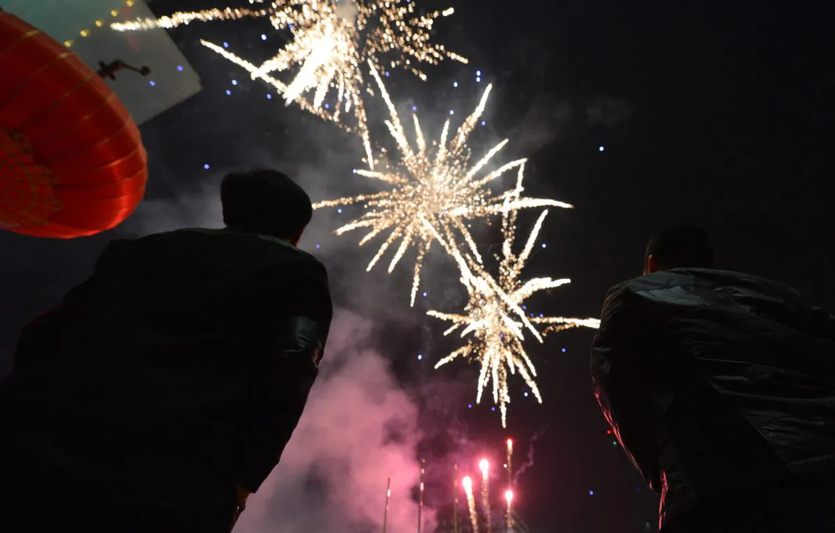 Chinese traders set off fireworks to acknowledge the 'god of wealth' outside the Silk Market and bring their businesses prosperity and good fortune on the fifth day of the lunar New Year in Beijing on Feb. 14, 2013. (Mark Ralston/AFP/Getty Images)