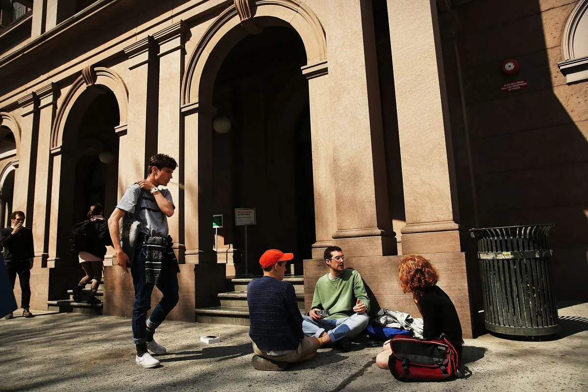 Students sit in front of Cooper Union for the Advancement of Science and Art, one of the last tuition-free colleges in the country, on April 24, 2013. (Photo by Spencer Platt/Getty Images)