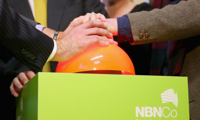 A detail of hands on the button pushed by Anthony Albanese, former deputy prime minister of Australia, to switch on the National Broadband Network (NBN) fibre network to an additional 2600 homes and businesses in Brunswick on July 24, 2013 in Melbourne, Australia. Analysts say the NBN plan is critical to ensuring faster broadband speeds into the future, as Australia falls behind countries like South Korea and the US. (Scott Barbour/Getty Images)
