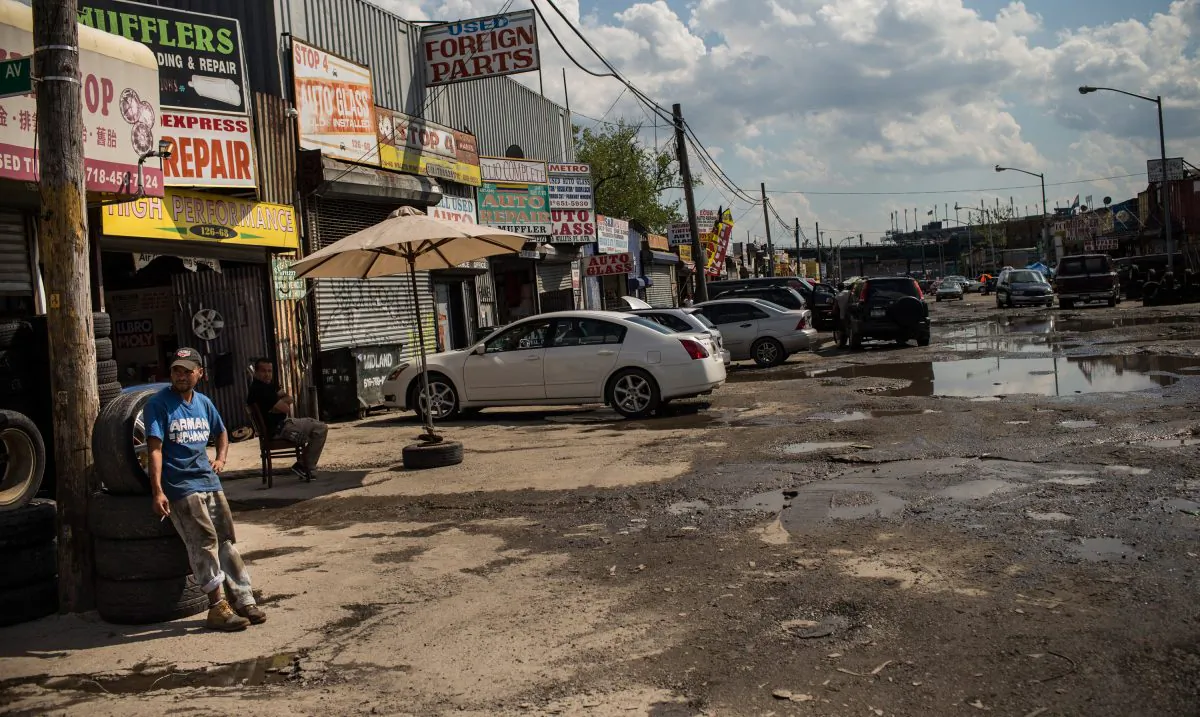 A man smokes a cigarette in the Willet's Point neighborhood of the Queens borough of New York City, Aug. 2, 2013. (Andrew Burton/Getty Images)