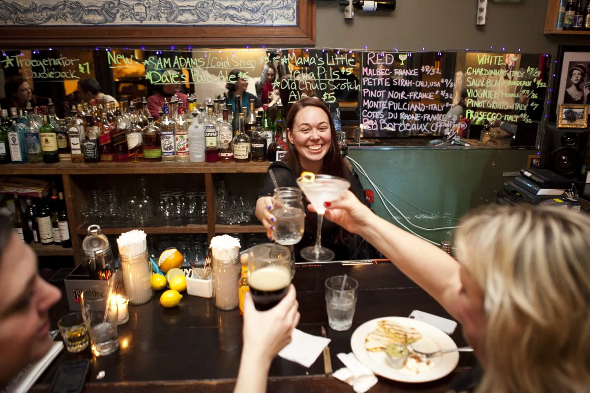 Bartender Nichole Osbourne toasts with Kathleen Joyce (L) and Jayne Williams at Meade's pub in South Street Seaport, New York, Feb. 19, 2014. Meade's Pub closed Feb. 23 because a new tenant will be paying twice the rent. (Samira Bouaou/Epoch Times)
