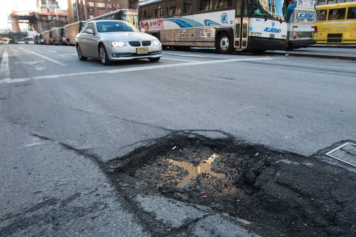 A pothole on 29th Street and Ninth Avenue in Manhattan, New York, on Feb. 26, 2014. Potholes have been appearing frequently in the city due to the freezing temperatures this winter. About 74 percent of roads are in poor or mediocre condition. (Petr Svab/Epoch Times) 