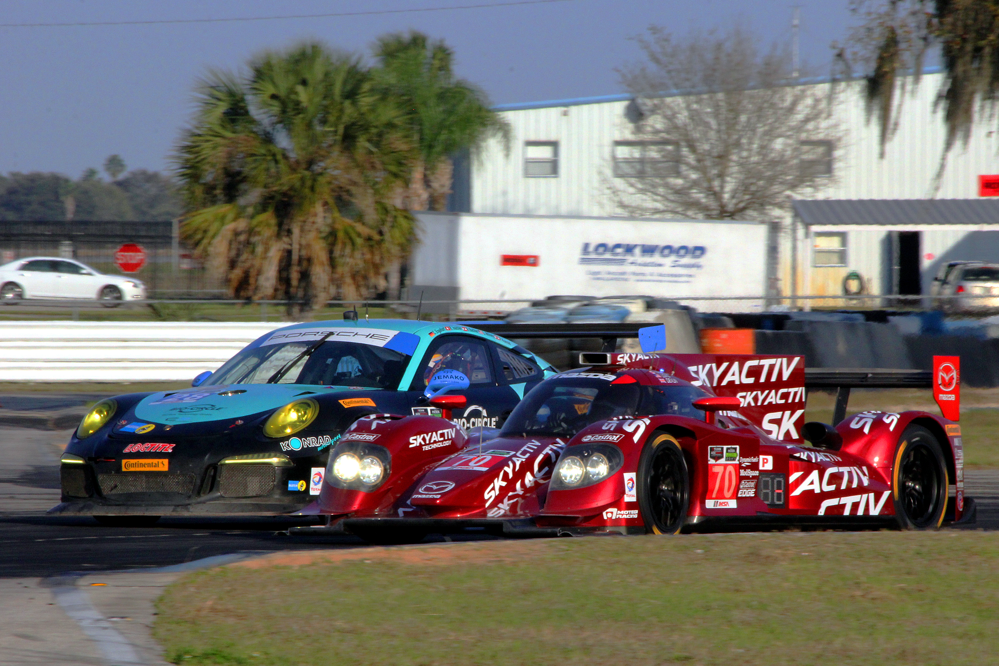 The #70 SpeedSource Mazda SkyActiv diesel P2 squeezes inside the #28 Dempsey Racing GTD Porsche at Turn Five Thursday afternoon. (Chris Jasurek/Epoch Times) The #70 SpeedSource Mazda SkyActiv diesel P2 squeezes inside the #28 Dempsey Racing GTD Porsche at Turn Five Thursday afternoon. (Chris Jasurek/Epoch Times)