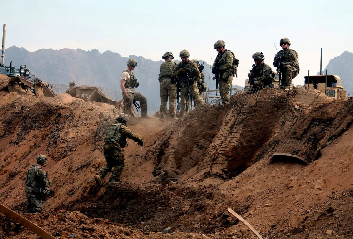 U.S. soldiers inspect the scene of a suicide attack outside a base in Zhari district, Kandahar province, Afghanistan, on Jan. 20, 2014. (Javed Tanveer/AFP/Getty Images)