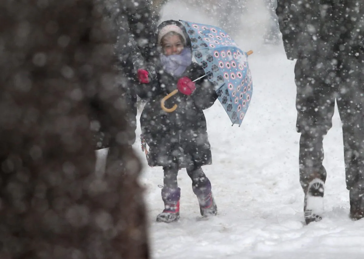 A child holds an umbrella as she walks to school during a snowstorm in New York City, Feb. 13, 2014. (John Moore/Getty Images)