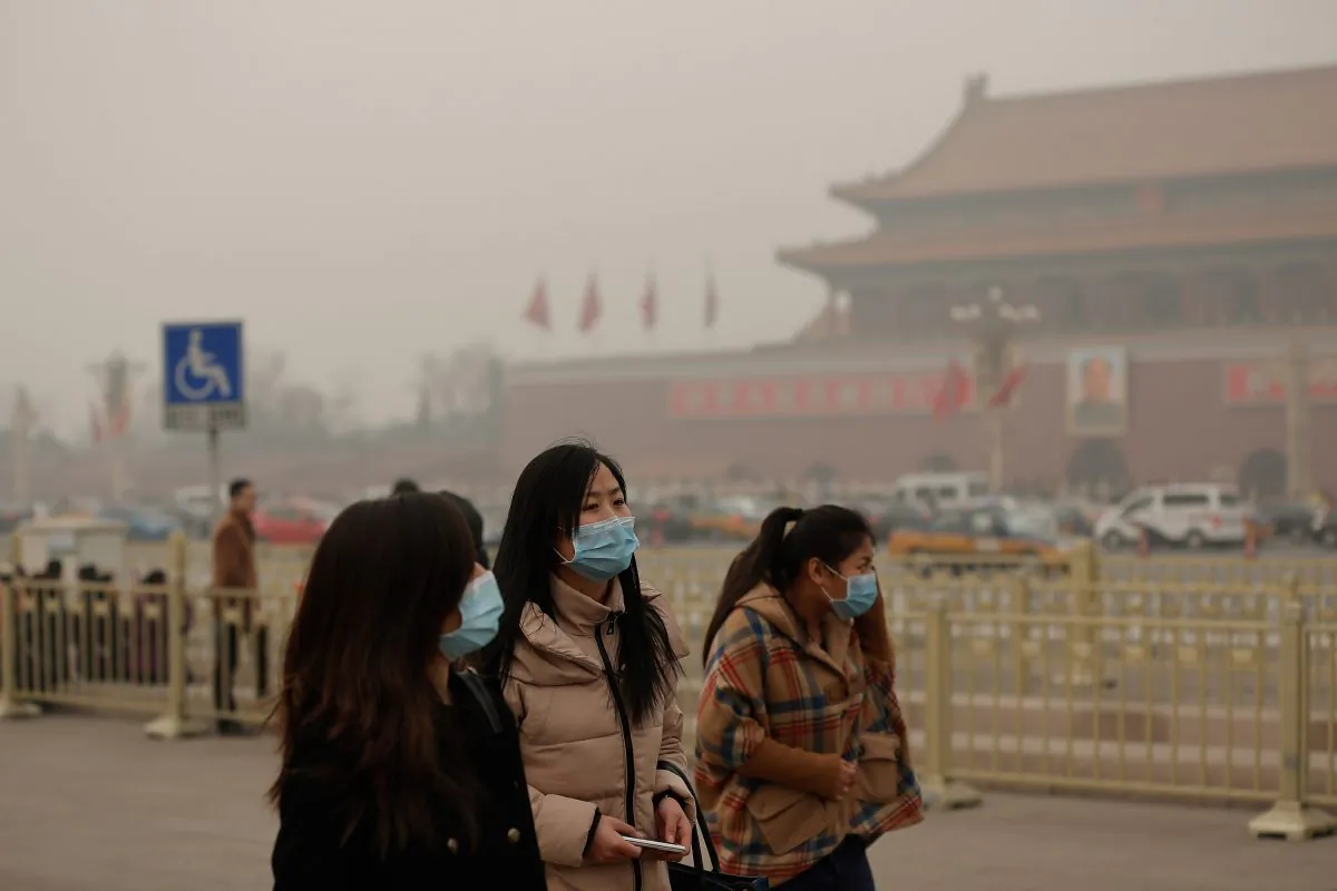 People walking on Tiananmen Square are wearing masks during severe pollution on Feb. 25, 2014 in Beijing, China. Emergency rooms for intravenous infusions and resuscitations have been overflowing with patients. (Lintao Zhang/Getty Images)