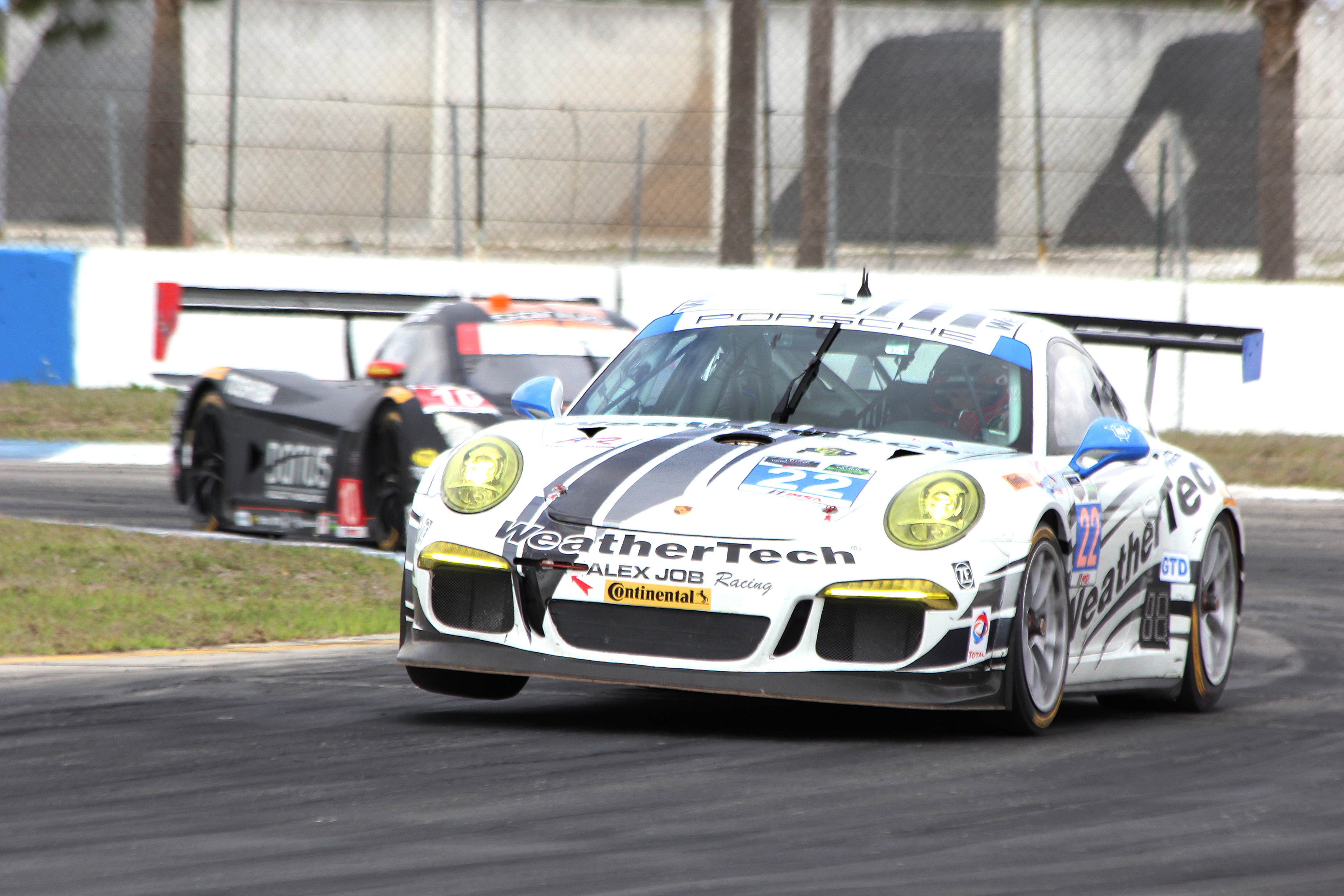 The #23 Alex Job Porsche tries to wheelie around Turn Ten. (Chris Jasurek/Epoch Times) The #23 Alex Job Porsche tries to wheelie around Turn Ten. (Chris Jasurek/Epoch Times)